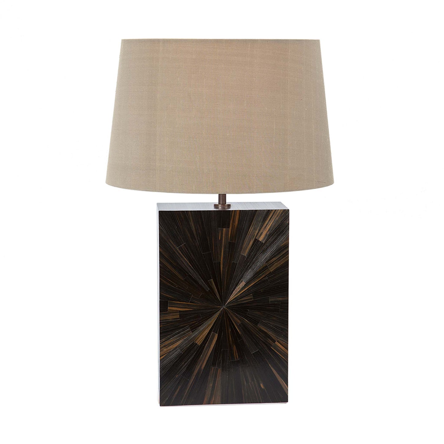 Straw marquetry lamp with a starburst pattern in a minimal rectangular block design in dark brown and black tones the lamp is shown with a beige tapered linen lampshade