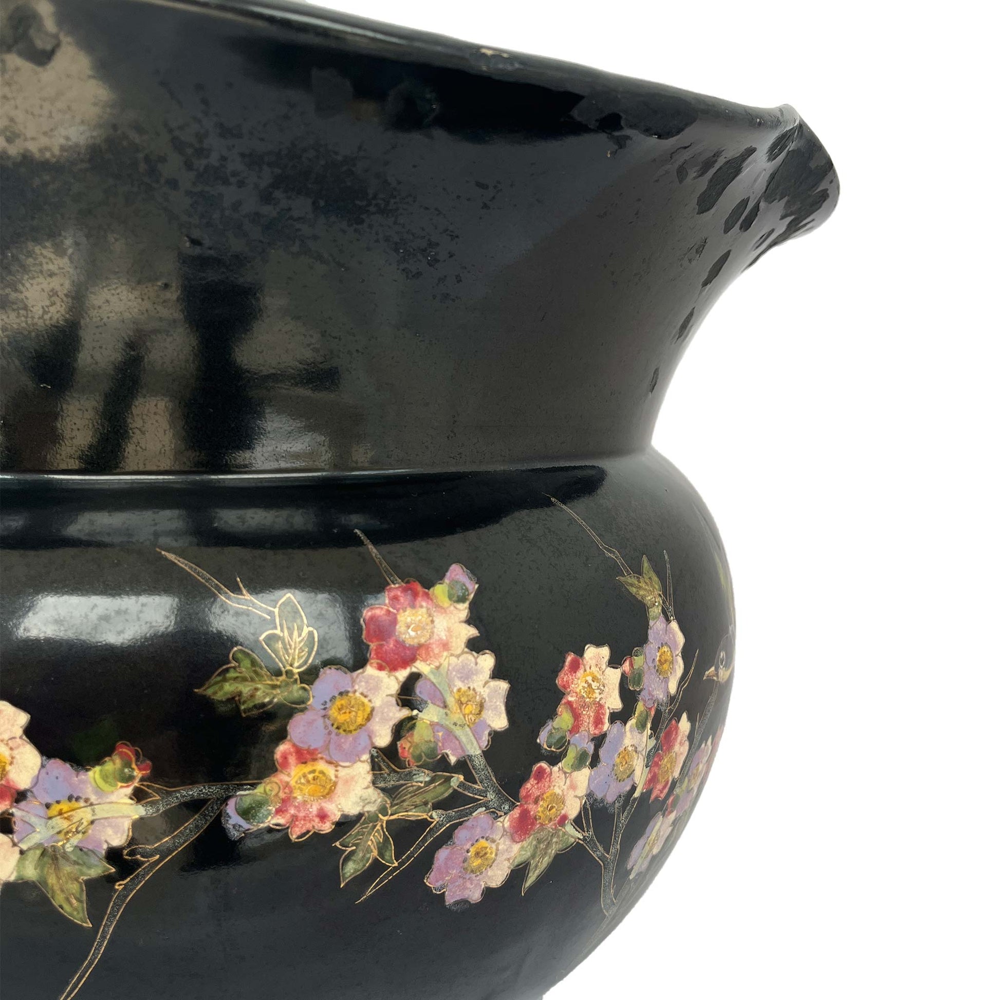 close up of large black jardiniere with bird and floral hand painted stem