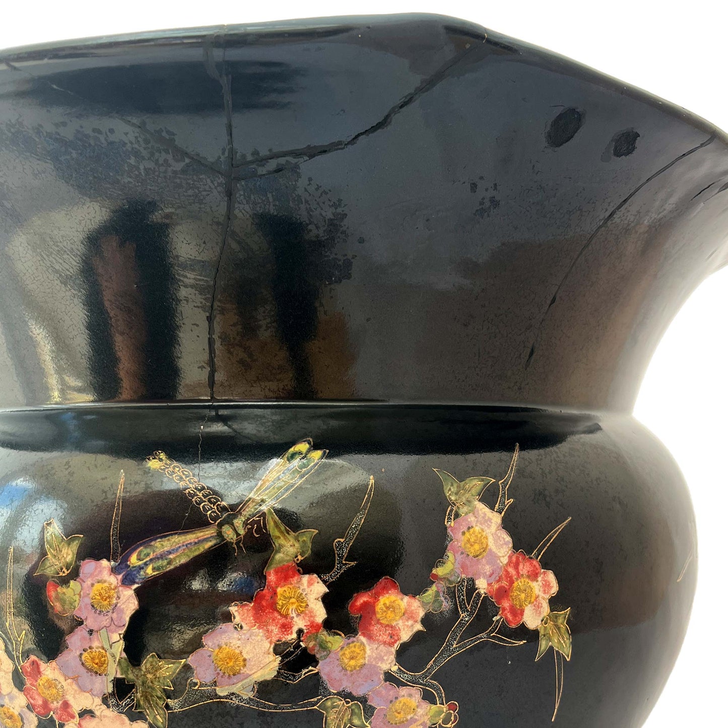 close up of large black jardiniere with bird and floral hand painted stem showing repairs