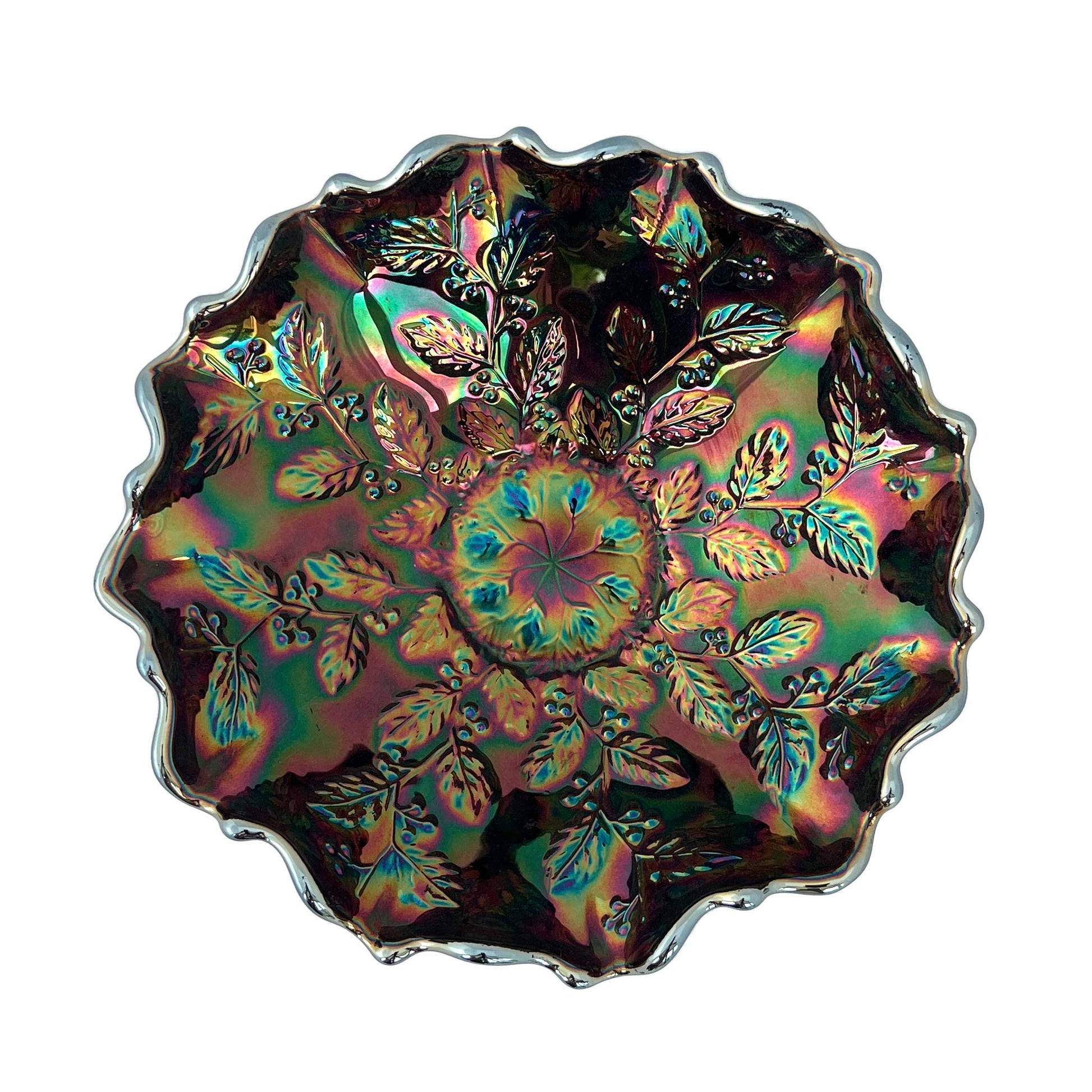 Fenton carnival glass bowl seen from above with leaf and berry design on interior and fluted rim. Shows rainbow colours.