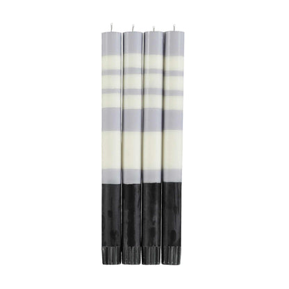 four tall striped candles in dove grey, pearl white, and jet black 