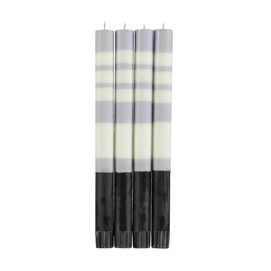 four tall striped candles in dove grey, pearl white, and jet black 