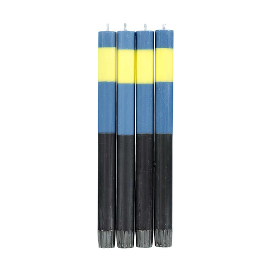 Four tall dinner candles. Striped blue, yellow, and black candles