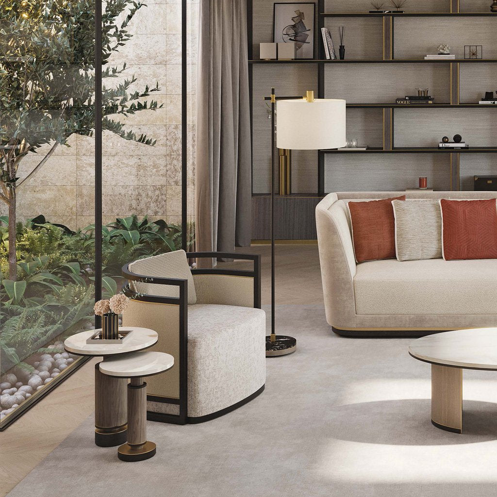 a lifestyle image of the two luxury brutalist side tables in a luxury living room besides an armchair