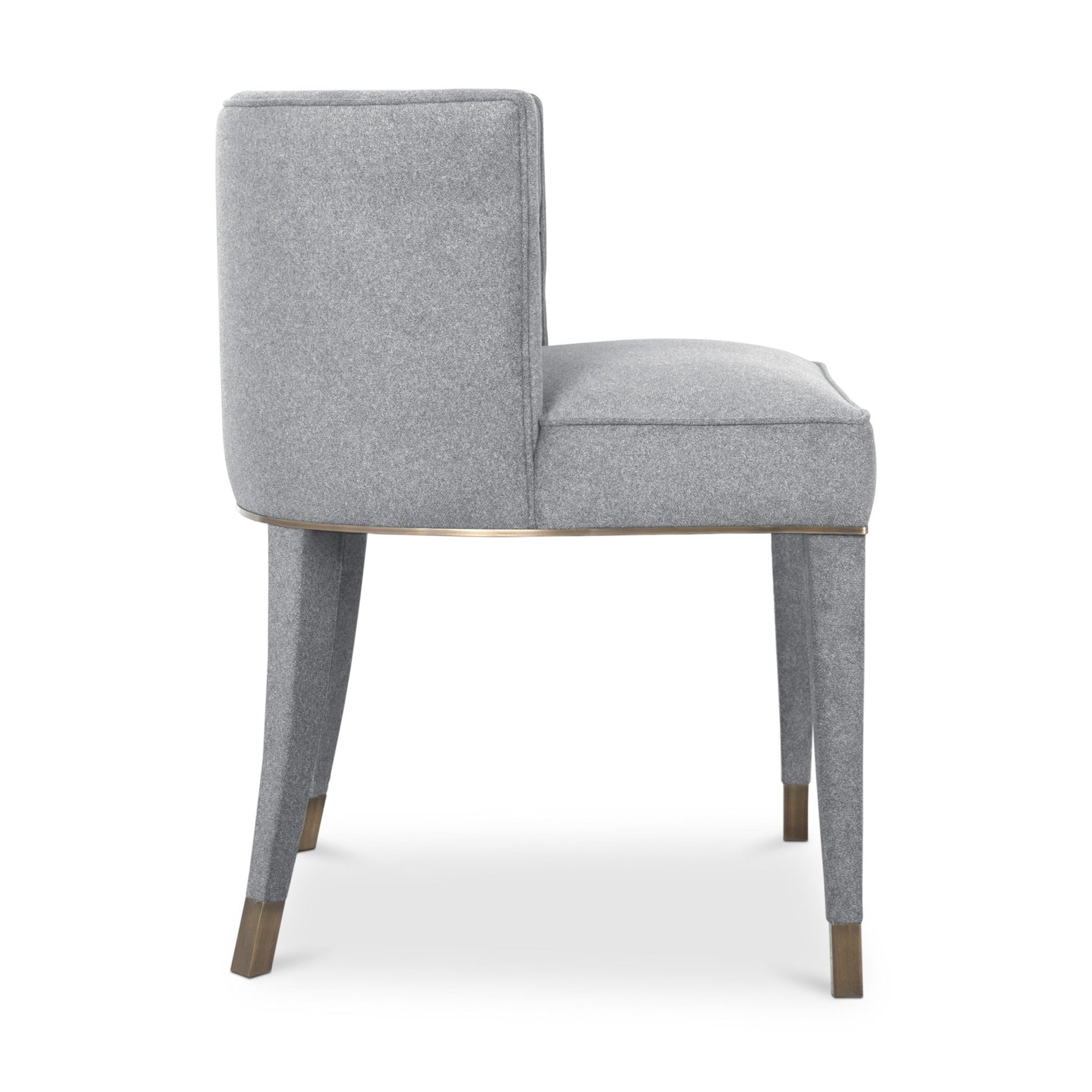 side view of the rich grey cotton velvet dining chair with a button-tufted inner back, upholstered legs, and aged brass detailing.