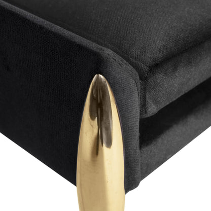 Close up of button tufted dressing table stool with stiletto type brass legs