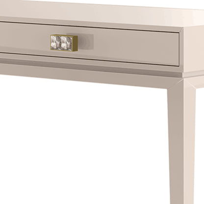 close up of the lacquered drawer front showing the pearl handles with brushed brass detailing