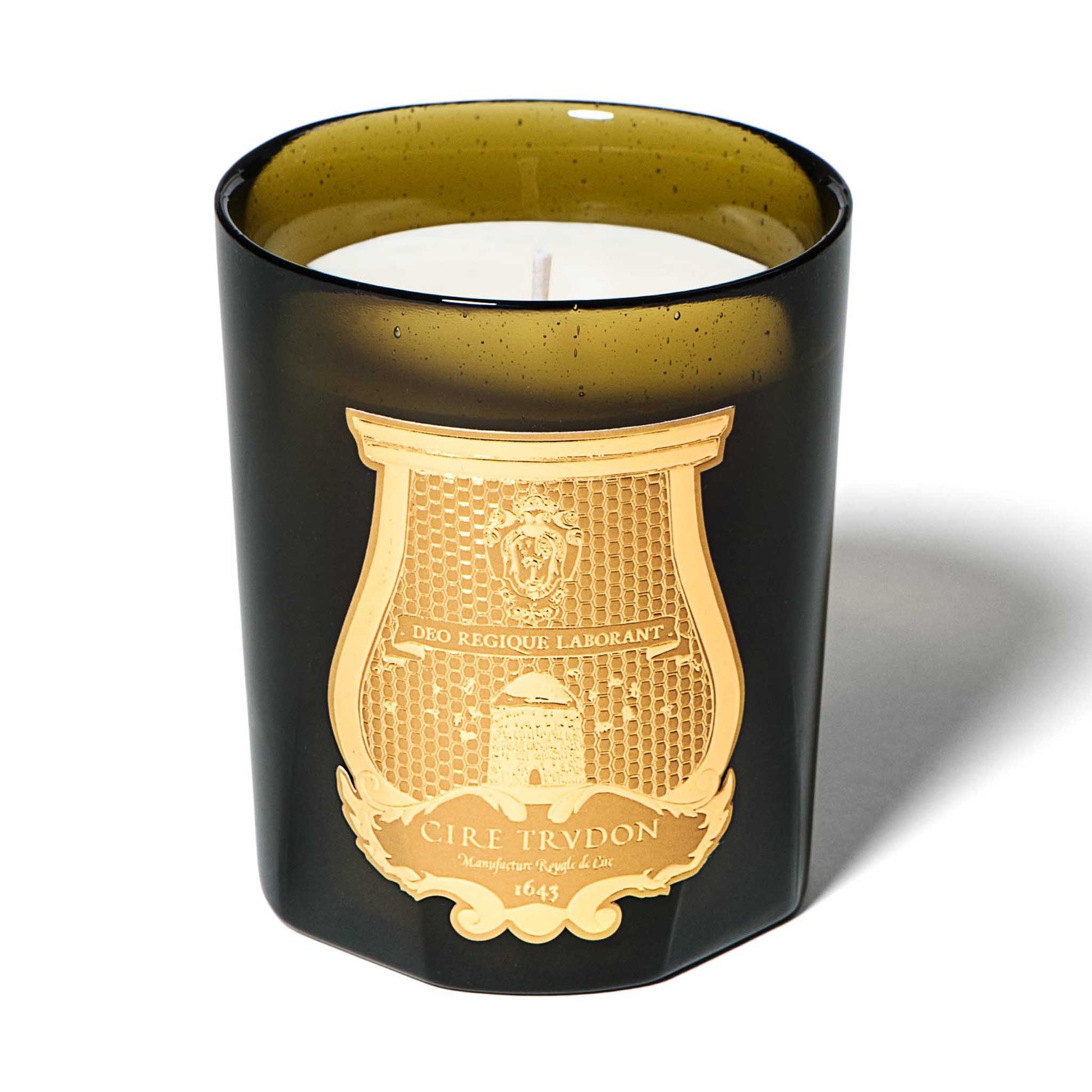 cire trudon candle in a green glass jar with a luxury gold label