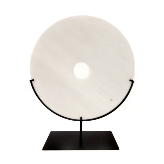 White marble bi disc displayed on a bronze stand. 