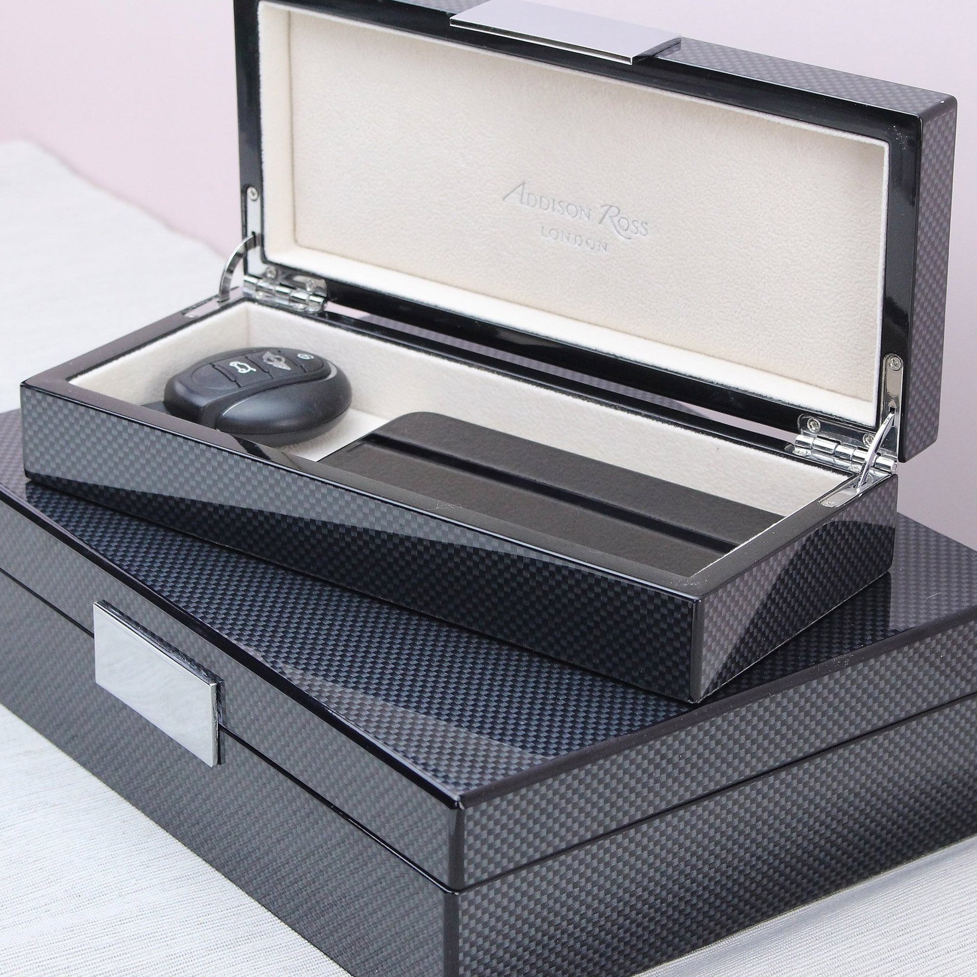 Carbon Fibre Lacquer Box, holding car keys and a phone, showing interior suede detaili