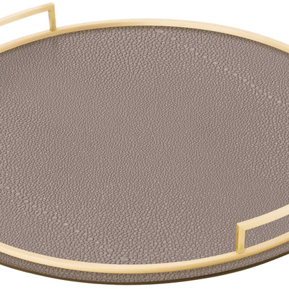Close up of round clay brown shagreen textured Italian leather tray with brass handles