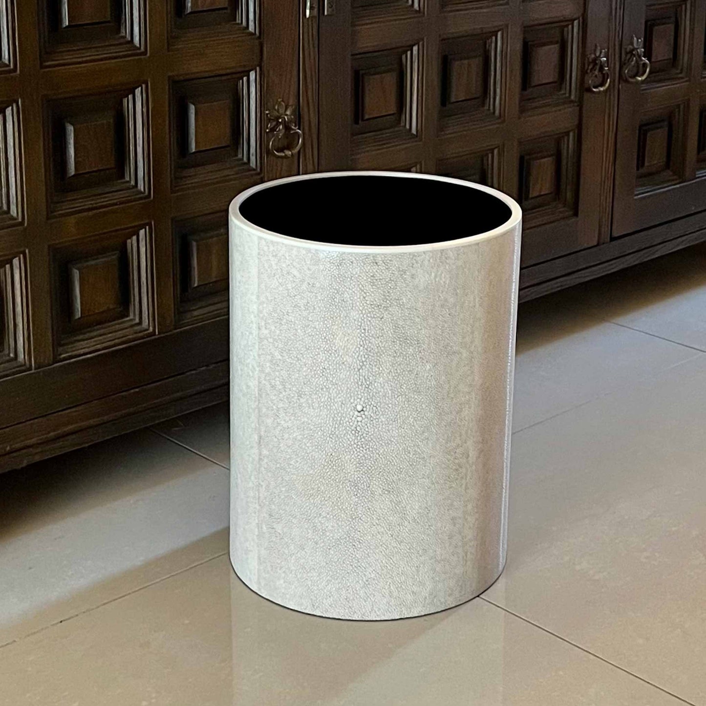 lifestyle image of the natural shagreen cylinder waste bin next to a hallway cabinet