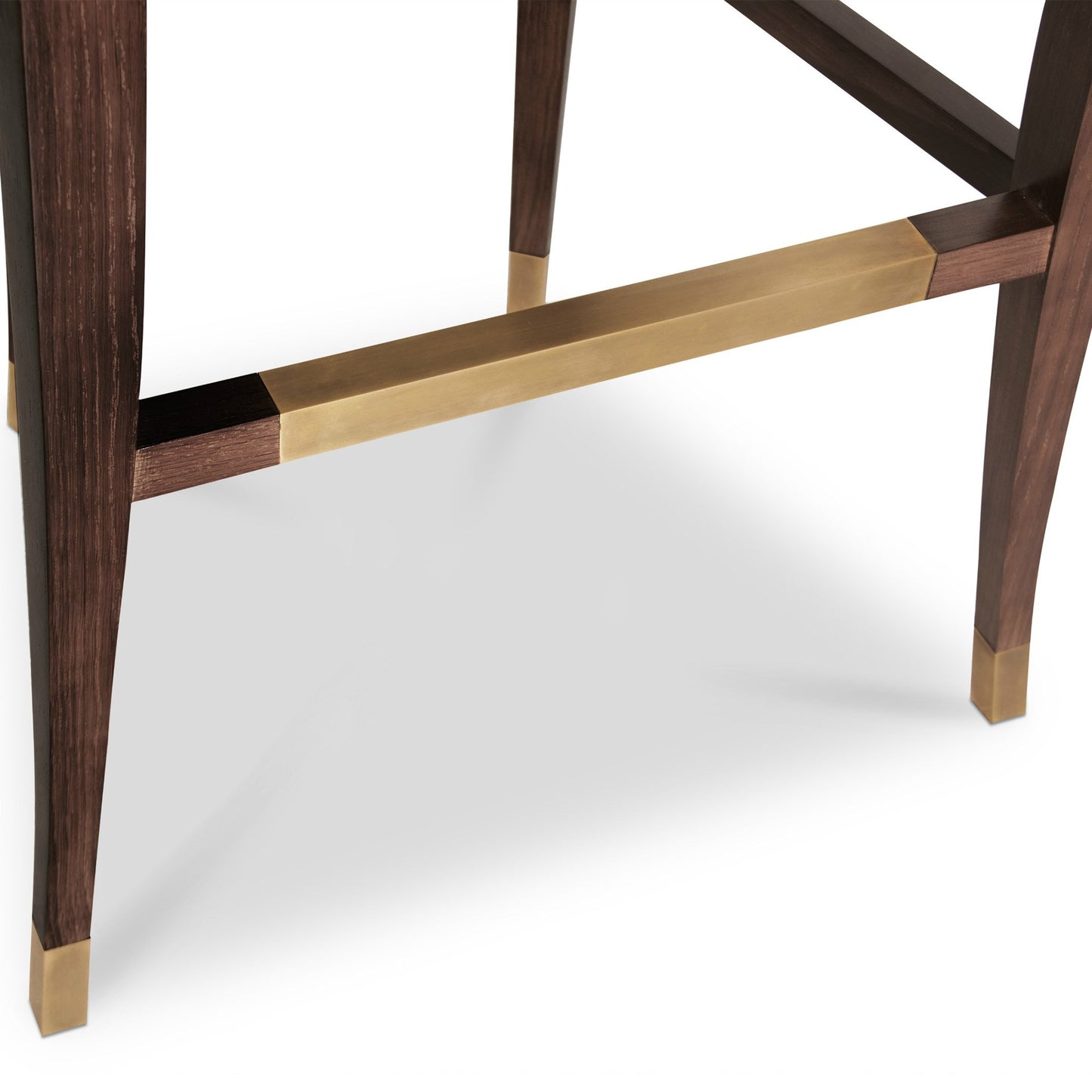 close up of the ash bar stool legs, showing the walnut stain finish and aged brass detailing