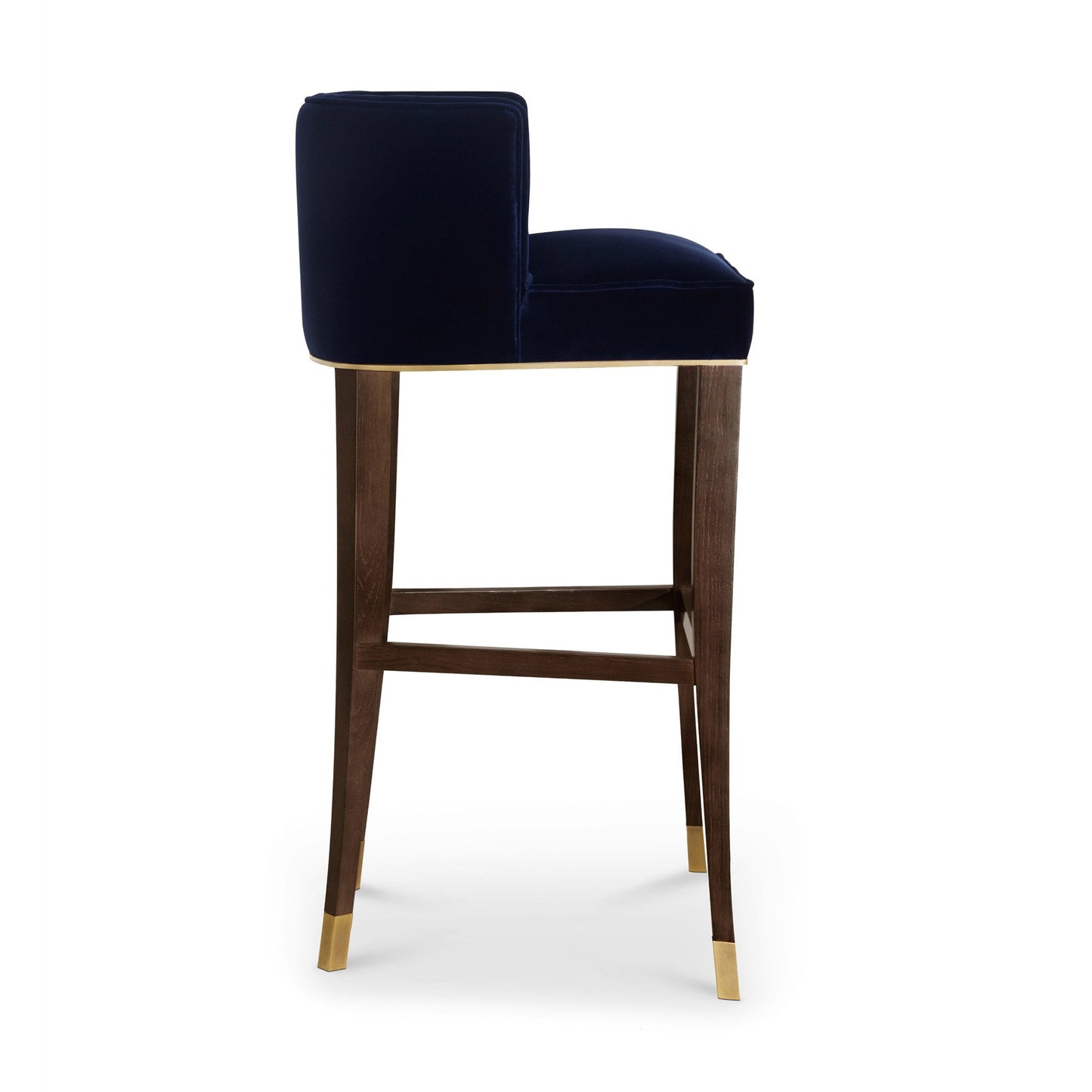 side view of the rich cotton velvet bar stool with a button tufted inner back and legs in ash, finished with a walnut stain and aged brass details