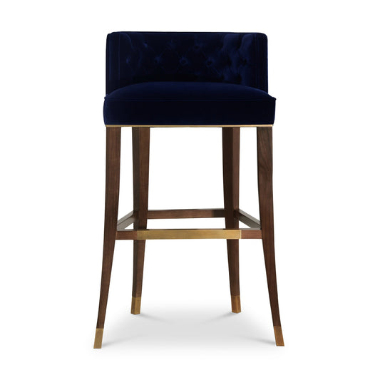 rich cotton velvet bar stool with a button tufted inner back and legs in ash, finished with a walnut stain and aged brass details