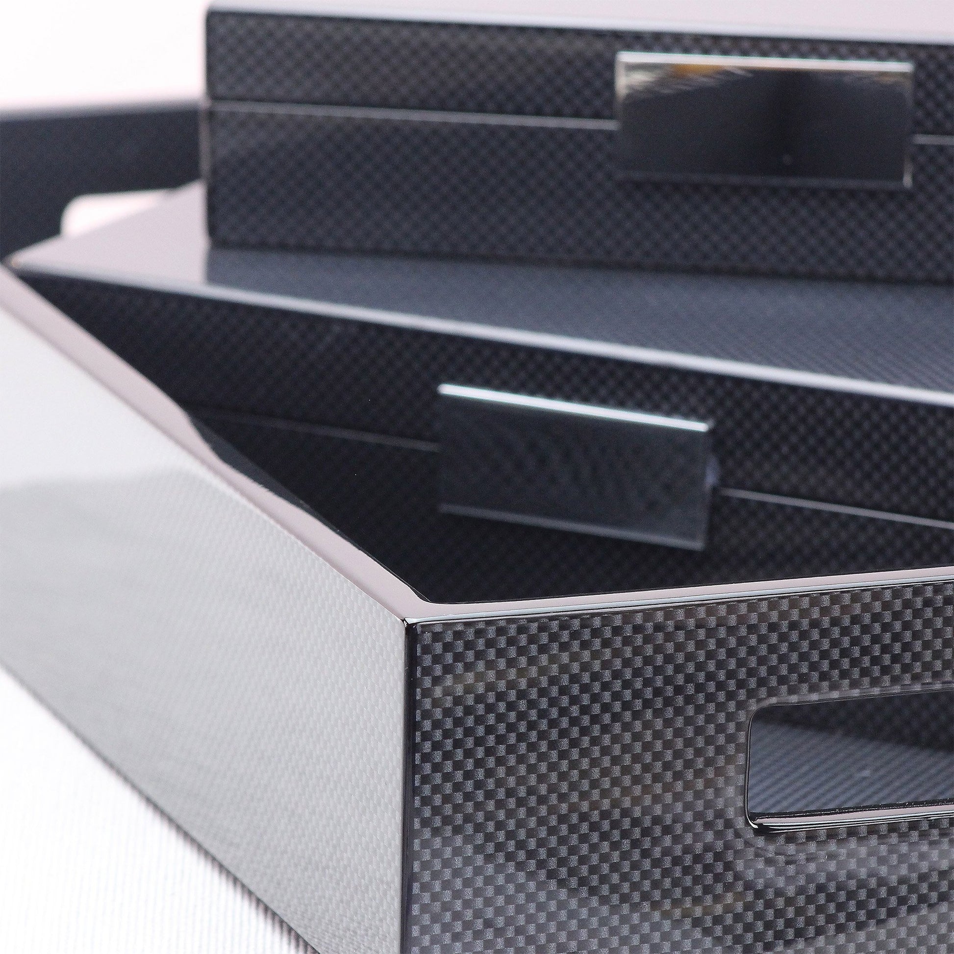 Close up of carbon black luxury large ottoman tray and other carbon desk accessories